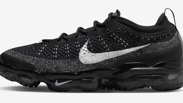 Side view of a black and white Nike shoe.